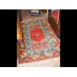 A Middle Eastern rug with geometric and floral pat