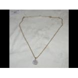 A circular diamond pendant on gold chain