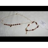 A lady's decorative necklace with garnet stone mo