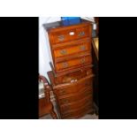 An antique style serpentine front chest of four dr
