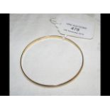 A 750 marked gold bangle