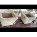 A pair of square stone plant pots