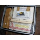 A box containing various model railway kits