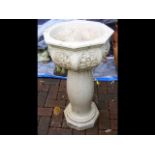 A decorative garden birdbath on stand