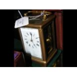 A 13cm high brass cased carriage clock with leathe