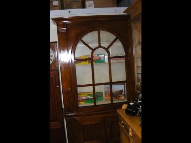 A Harrods of London glazed bookcase with arched do