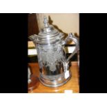 A 36cm high silver plated lidded jug, together wit