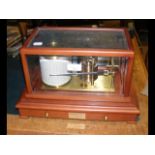 A modern barograph with chart case below