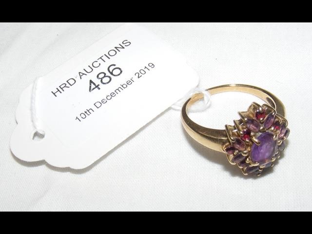 A lady's purple stone dress ring in gold mount