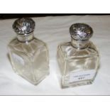 A pair of silver top scent bottles
