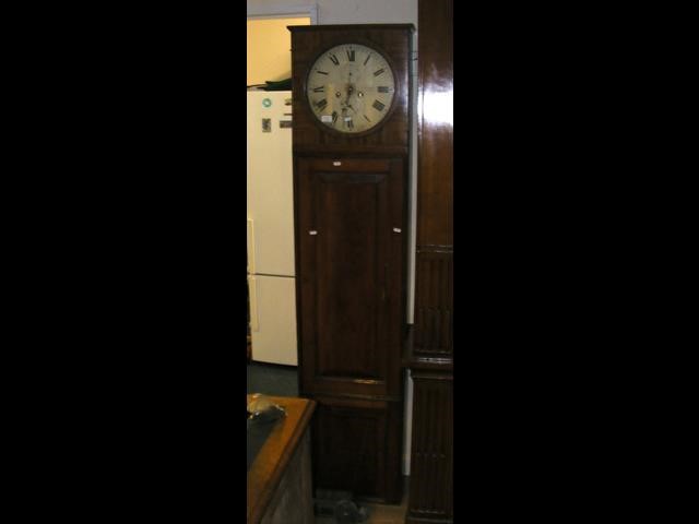 An antique circular regulator style longcase clock