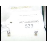 A pair of diamond stud earrings - approx. 0.22 car
