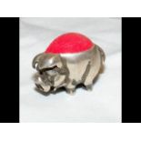 A very small white metal pig novelty pincushion -