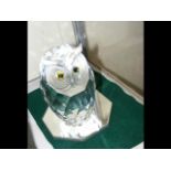 A large boxed Swarovski Owl ornament on mirrored b