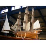 A wooden three masted model ship, together with a
