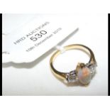 An opal and diamond ring in 18ct gold setting