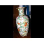 An oriental vase with floral decoration and mark t
