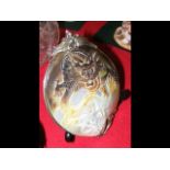 An antique carved oyster shell with metal mounts -