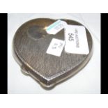 A silver heart shape compact