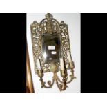 A pierced brass wall sconce