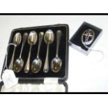 A cased set of six silver teaspoons, together with