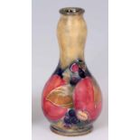 AN EARLY 20th CENTURY MINIATURE WILLIAM MOORCROFT POMEGRANATE VASE signed WM and impressed marks