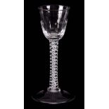 AN 18TH CENTURY CORDIAL GLASS with ogee fluted bowl above a plain six-ply spiral band outside a