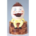 AN EARLY 20TH CENTURY PORCELAIN NOVELTY STAMP LICKER IN THE FORM OF HUMPTY DUMPTY brightly painted