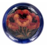 A MOORCROFT 'BIG POPPY' DESIGN DISH with dark blue ground 11cm diameter