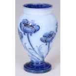 AN EARLY 20th CENTURY MINIATURE MOORCROFT MACINTYRE FLORIAN WARE VASE pale blue poppy pattern, on