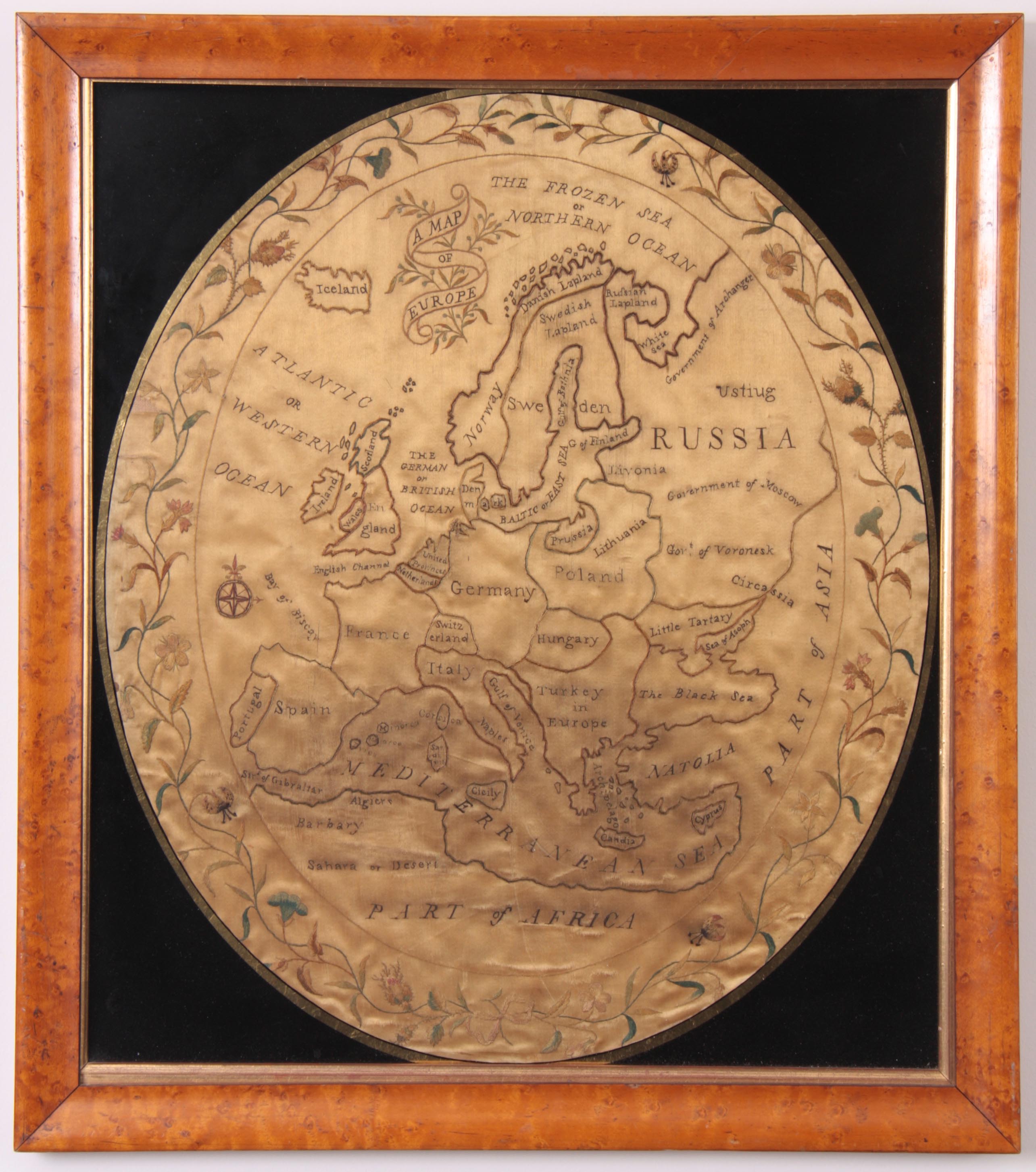 AN EARLY 19TH CENTURY SILKWORK MAP OF EUROPE circa 1800 - in a glazed birds eye maple moulded