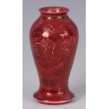 A MOORCROFT, BURSLEM RED LUSTRE GLAZED INVERTED BALUSTER MINIATURE VASE with blooming flower spray