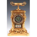 A LATE 19TH CENTURY FRENCH ORMOLU AND PIETRA DURA MANTEL CLOCK with urn finial above a waisted