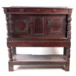 AN LATE 17TH CENTURY AND LATER OAK BUFFET with geometric moulded fronted cupboards flanked by ring