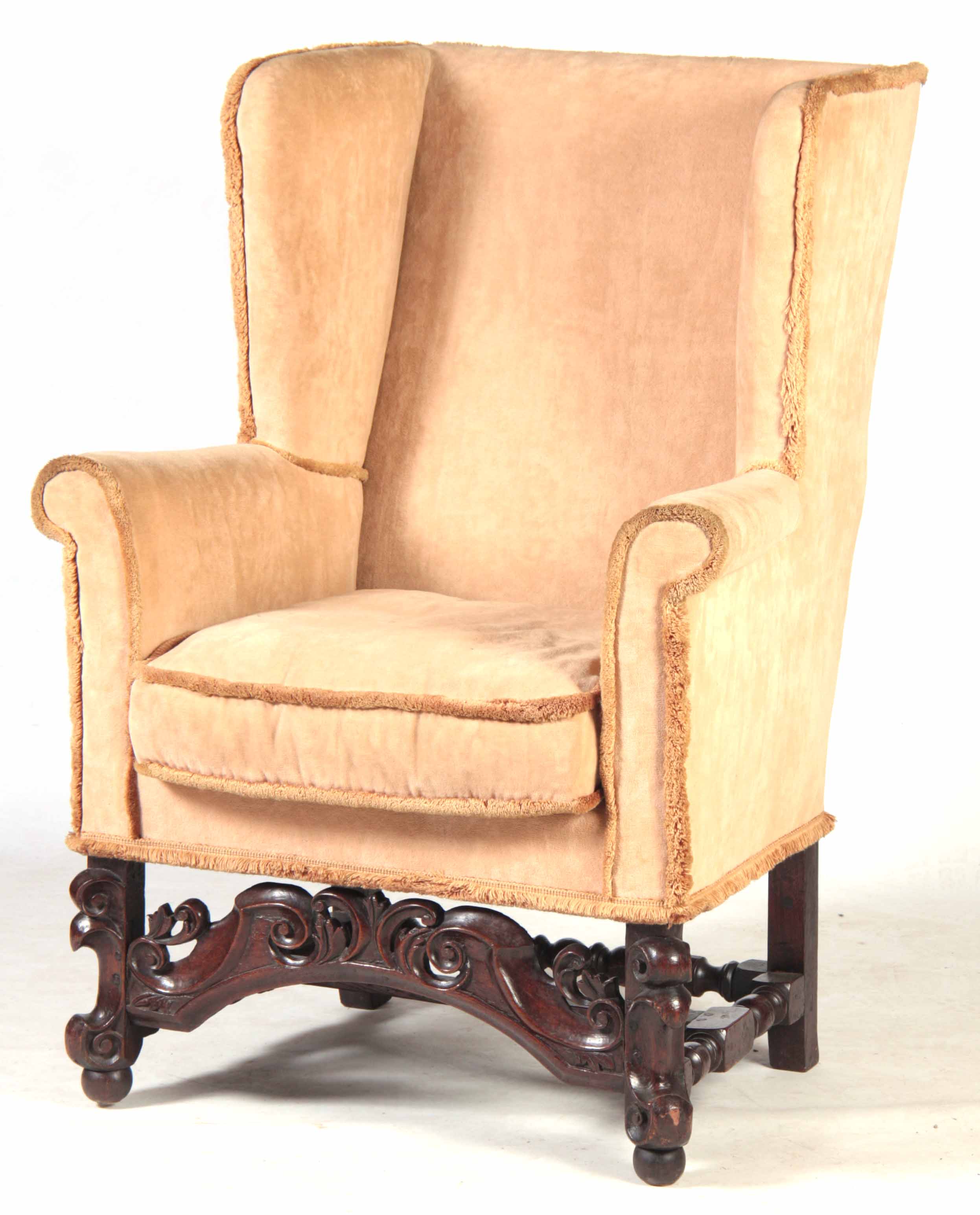 A 17TH CENTURY OAK WINGBACK ARMCHAIR with upholstered back, scrolled arms and loose cushion;