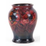 A 20TH CENTURY WALTER MOORCROFT FLAMBE GLAZED POPPY VASE of baluster form bearing painted and