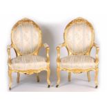 A PAIR OF 19TH CENTURY FRENCH LOUIS XVI GILT GESSO CARVED ARMCHAIRS with flower head carved