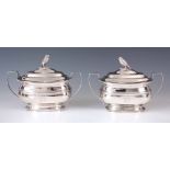 A PAIR OF GEORGE III SAUCE TUREENS of oblong form with domed lids surmounted by owl finials, the