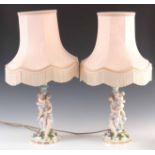 A PAIR OF LATE 19TH CENTURY MEISSEN STYLE FIGURAL TABLE LAMPS decorated with rose petals on rococo