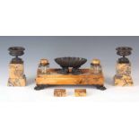 A 19TH CENTURY ITALIAN BRONZE AND SIENNA MARBLE DESK SET COMPRISING OF AN INKSTAND, A PAIR OF TAZZAS