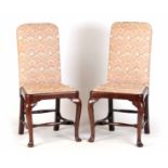 A PAIR OF GEORGE II MAHOGANY UPHOLSTERED SIDE CHAIRS with covered backs and drop in seats;