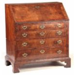A QUEEN ANNE FIGURED WALNUT BUREAU with cross-banded and strung edges, the angled fall revealing a