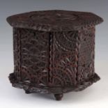 AN EARLY 19TH CENTURY WELSH CHIP CARVED OAK OCTAGONAL TABLE CABINET with Celtic style pierced top