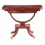 A REGENCY EBONY STRUNG FLAMED MAHOGANY CARD TABLE with rounded corners revelling a swivelling