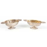 A PAIR OF 19TH CENTURY DUTCH SILVER BRANDY BOWLS with repoussé decoration having gilt interior of