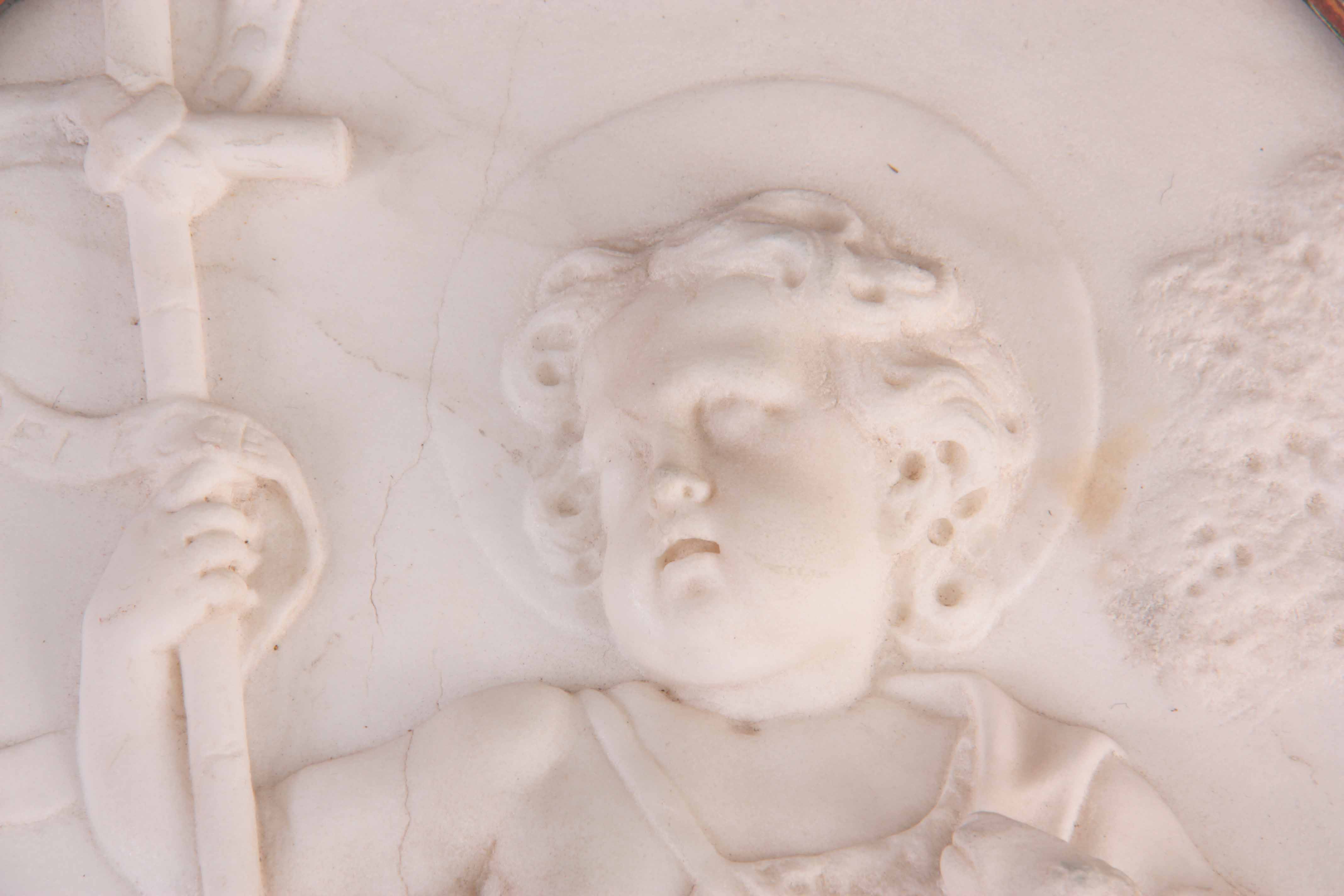 AN 18TH CENTURY OVAL CARVED WHITE MARBLE HANGING WALL PLAQUE depicting a young angel holding a - Image 3 of 7