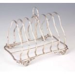A LATE 19th CENTURY SILVER TOASTRACK having loop handle and knotted feet 13cm high, 16cm wide,