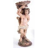 AN EARLY 17TH CENTURY CONTINENTAL CARVED POLYCHROME FIGURE DEPICTING ST. SEBASTION entwined to