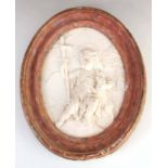 AN 18TH CENTURY OVAL CARVED WHITE MARBLE HANGING WALL PLAQUE depicting a young angel holding a