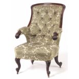 A MID 19TH CENTURY ROSEWOOD ARM CHAIR having a leaf carved frame, upholstered button back and